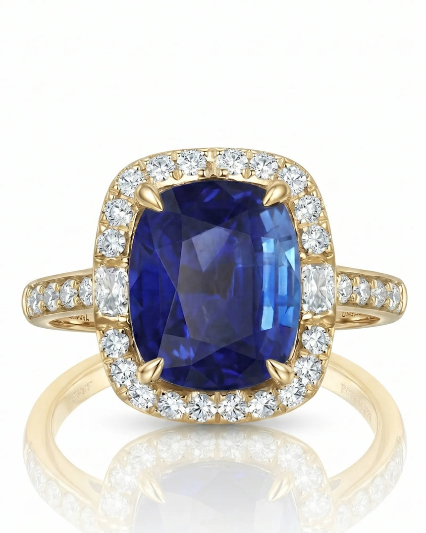 Natural cushion sapphire ring framed by bright round diamonds in 18K yellow gold | SARATTI