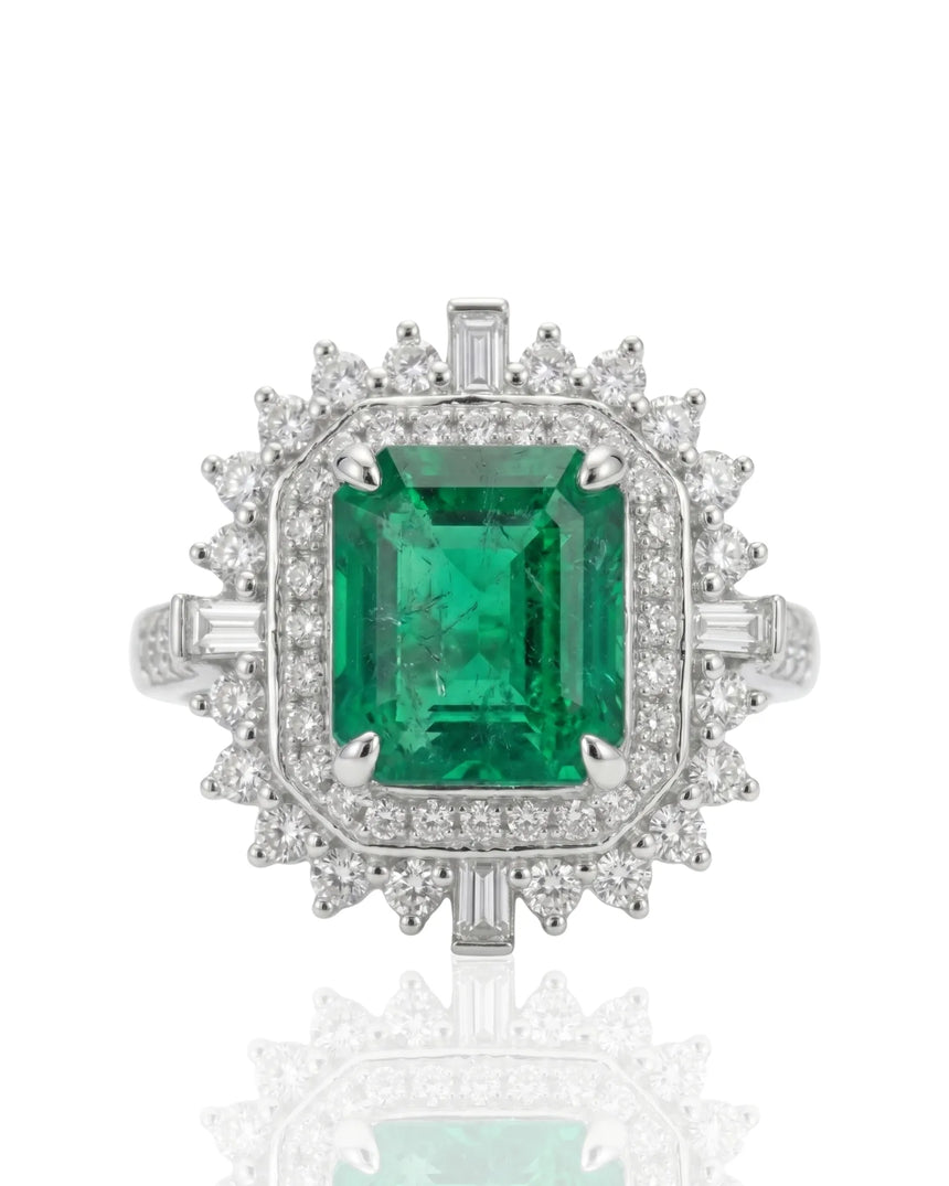 Natural emerald sunburst ring with diamond cluster frame in platinum | SARATTI
