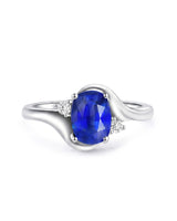 Natural oval blue sapphire ring with two diamond accents in platinum | SARATTI