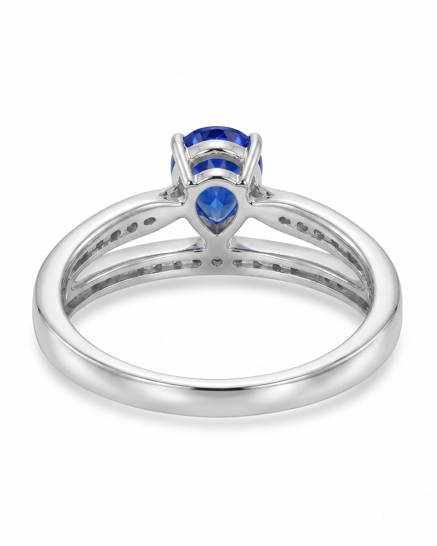Natural pear blue sapphire ring with round diamond accents in polished platinum | SARATTI