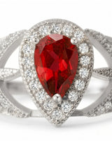 Natural pear ruby ring with bright diamond halo and white gold setting | SARATTI