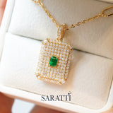 18K gold pavillion pendant with emerald center and structured diamond detailing | SARATTI