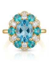 Oval Swiss Blue topaz ring framed by teal apatites and round diamonds in 18K yellow gold | SARATTI