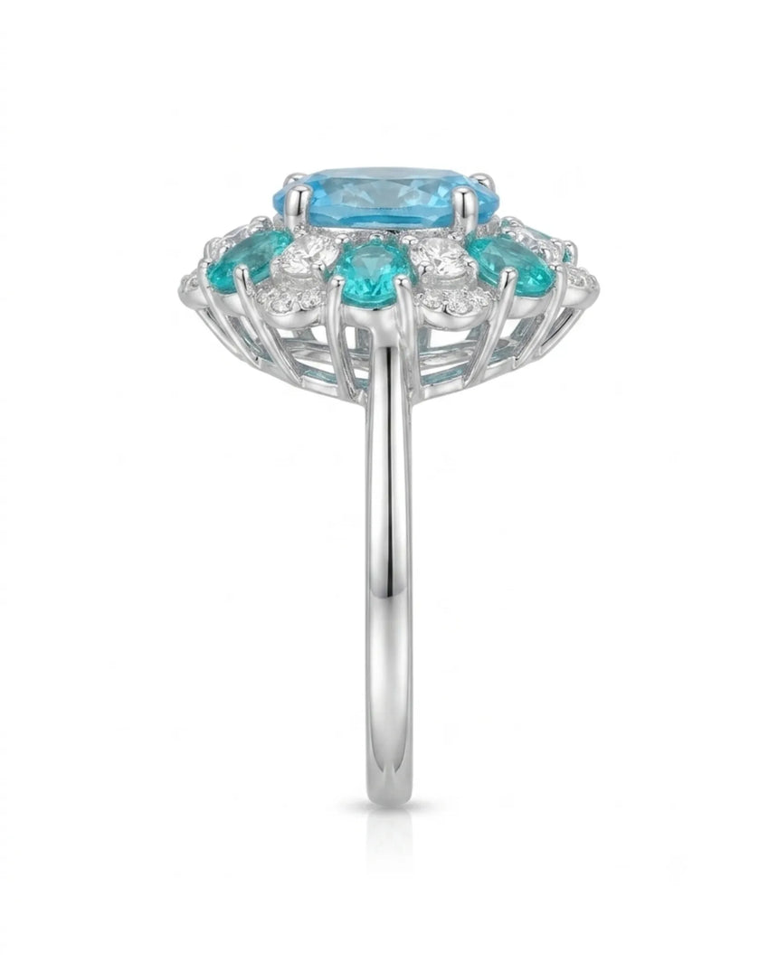 Oval Swiss Blue topaz ring framed by teal apatites and round diamonds in platinum | SARATTI