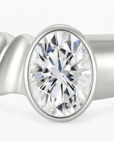 Oval bezel moissanite engagement ring for a minimalist modern proposal in 18K white gold | SARATTI