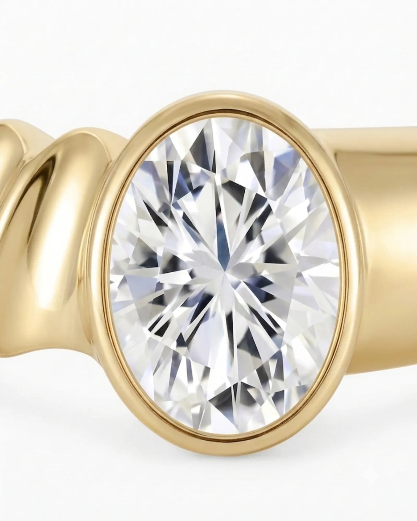 Oval bezel moissanite engagement ring for a minimalist modern proposal in 18K yellow gold | SARATTI