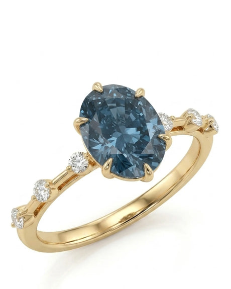 Oval blue moissanite engagement ring with round shoulder accents in 18K yellow gold | SARATTI