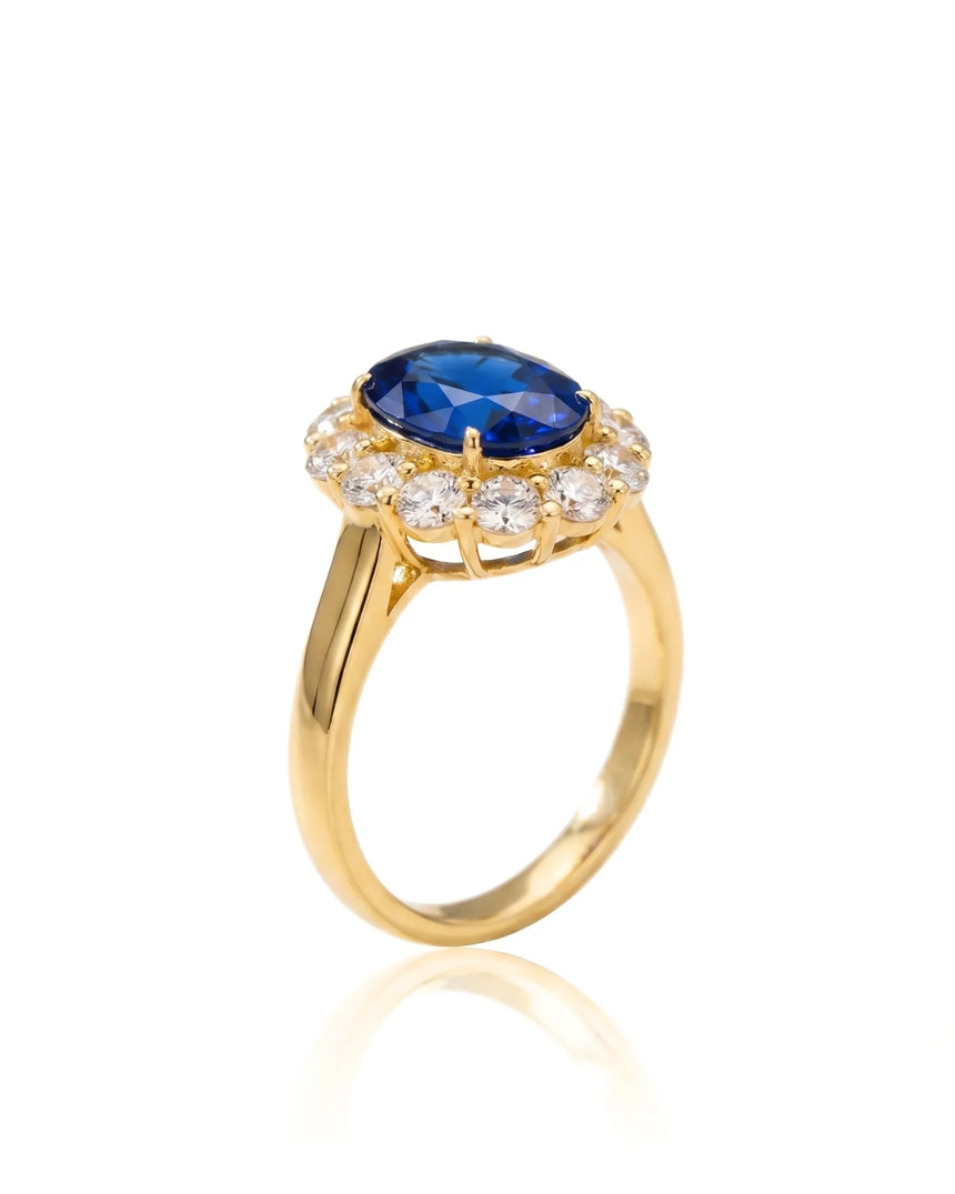 Oval blue sapphire engagement ring with round diamond halo in 18K yellow gold | SARATTI
