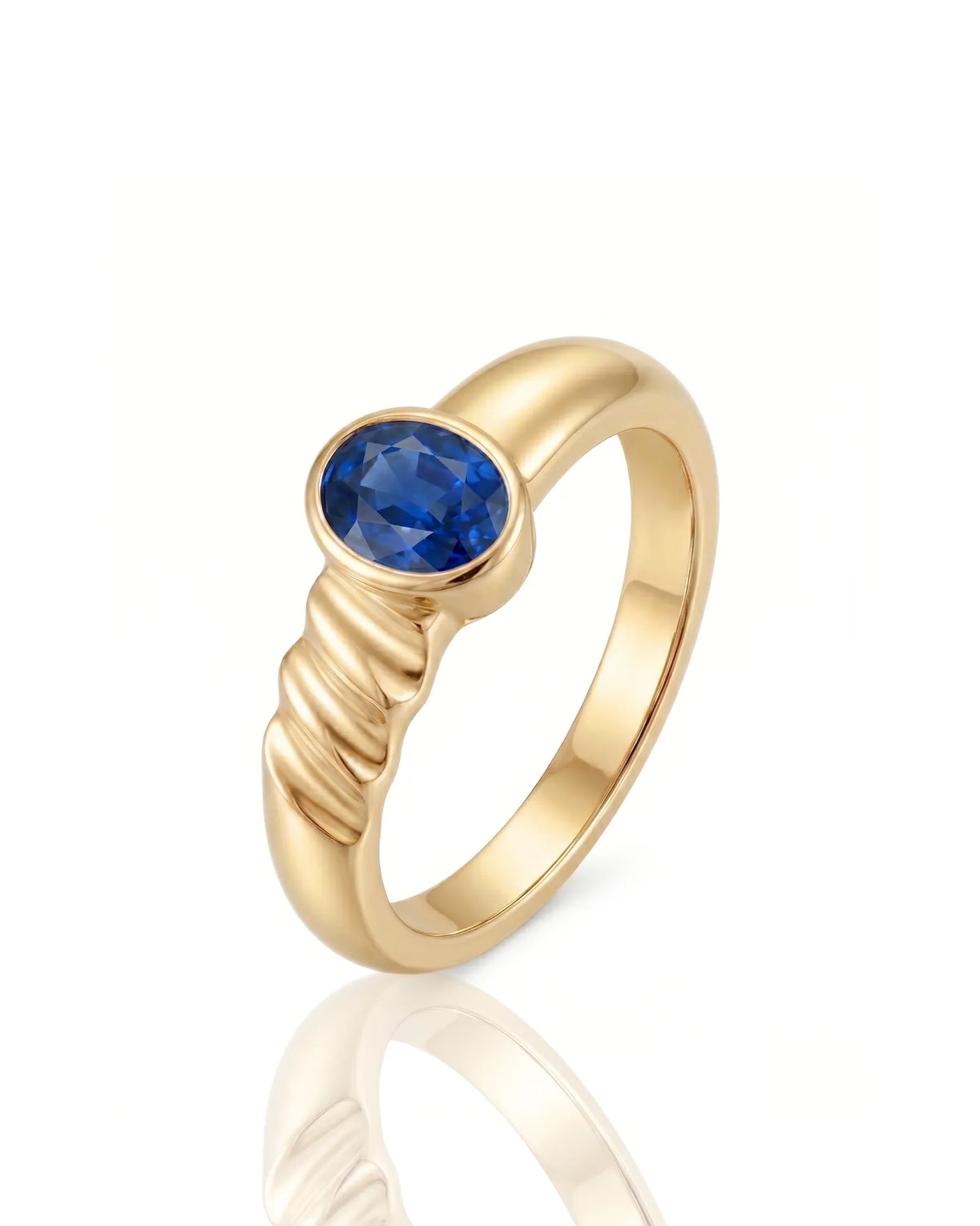 Oval blue sapphire solitaire ring with bezel setting and grooved 18K Yellow Gold band | SARATTI