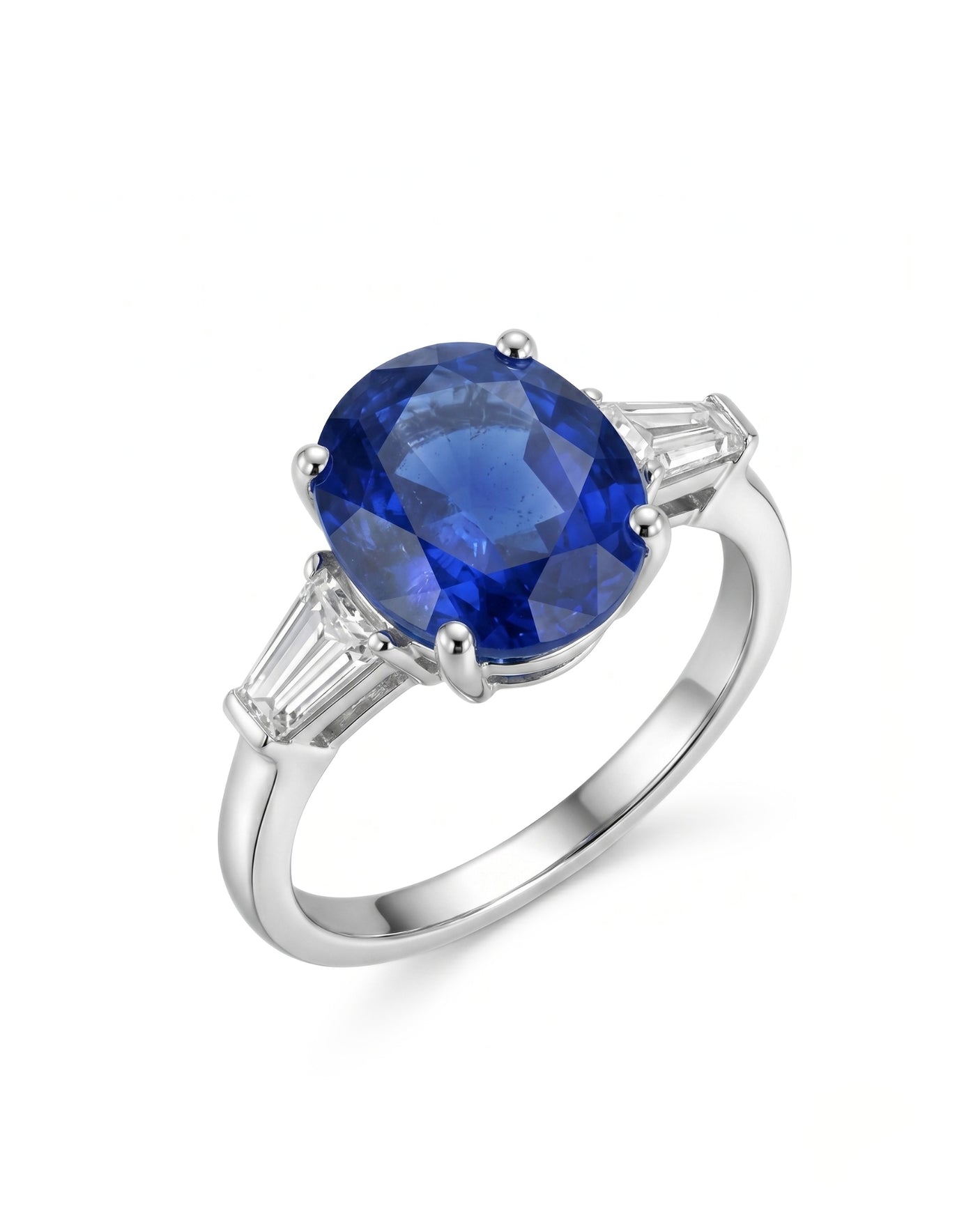 Oval blue sapphire three-stone ring with baguette diamond accents in 18K white gold | SARATTI