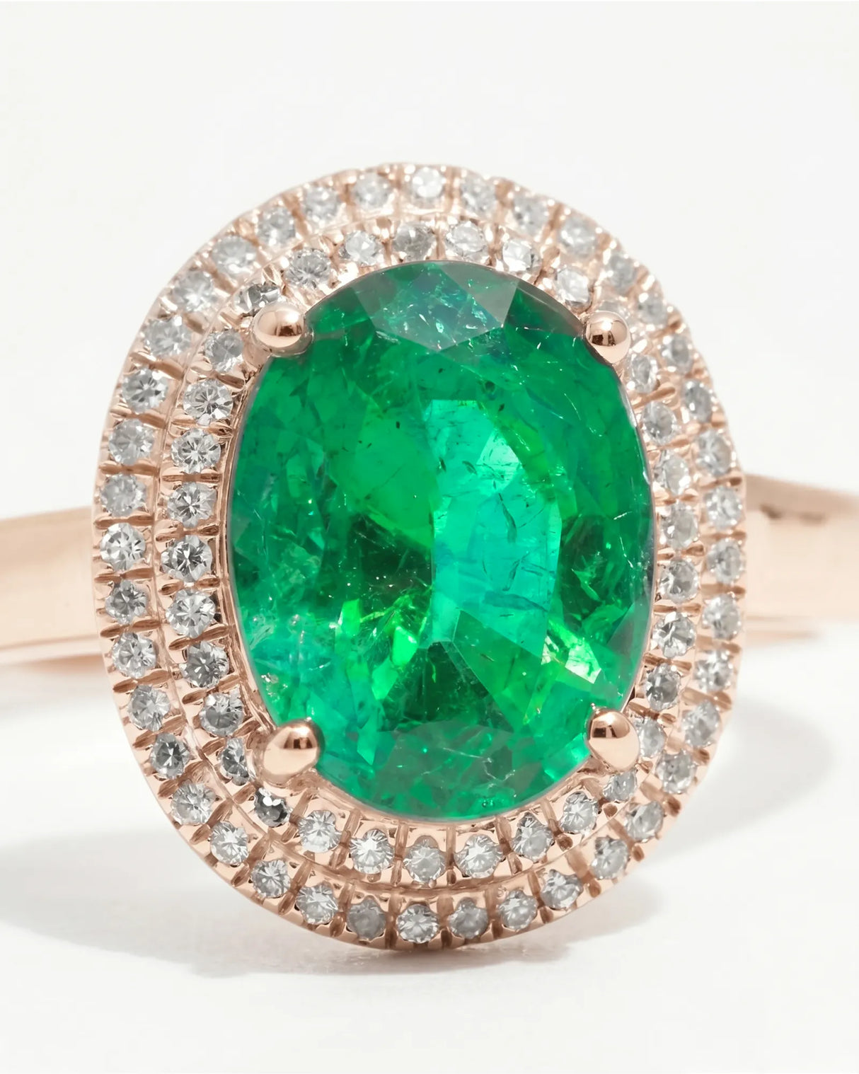 Oval cut natural emerald halo ring with diamond accents in rose gold | SARATTI