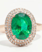 Oval cut natural emerald halo ring with diamond accents in rose gold | SARATTI