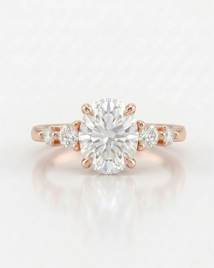 Oval five stone moissanite engagement ring for a romantic proposal in 18K rose gold | SARATTI