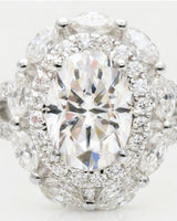 Oval halo moissanite engagement ring for a refined romantic proposal crafted in platinum | SARATTI