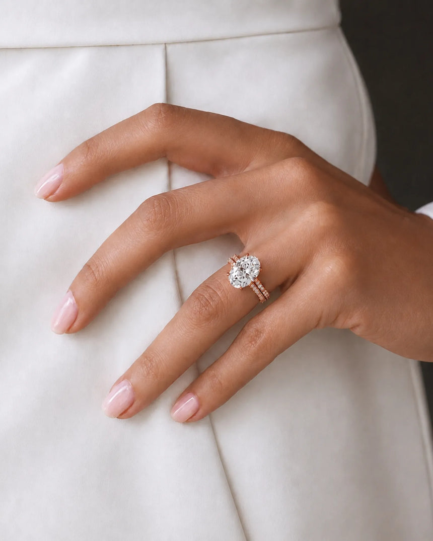 Oval moissanite engagement and wedding ring set with hidden halo crafted in 18K rose gold | SARATTI