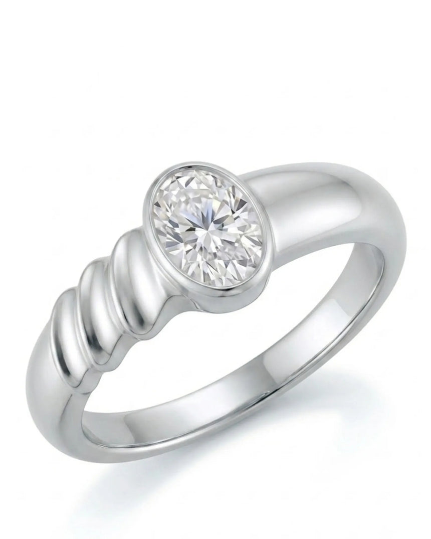 Oval moissanite engagement ring with bezel setting and sculpted wave band crafted in platinum | SARATTI