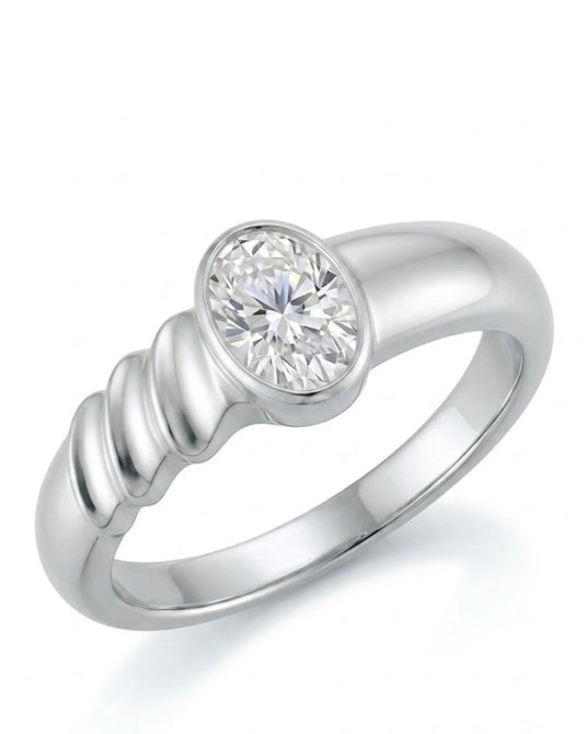 Oval moissanite engagement ring with bezel setting and sculpted wave band in 18K white gold | SARATTI