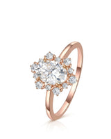 Oval moissanite engagement ring with floral halo and round accents in 18K rose gold | SARATTI