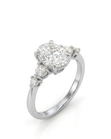 Oval moissanite engagement ring with graduated round side stones in 18K white gold | SARATTI