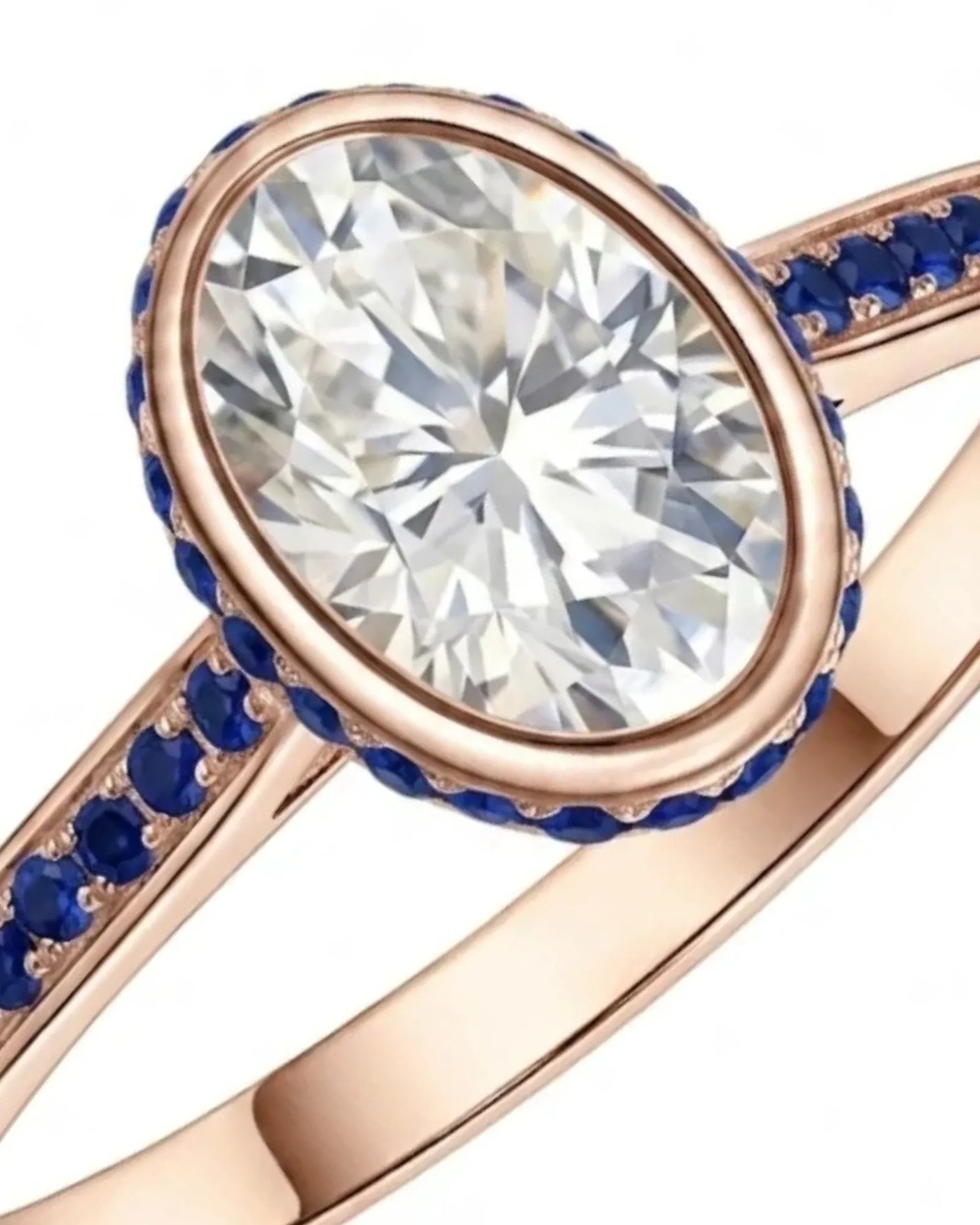 Oval natural diamond ring accented by round blue sapphires in polished 18K rose gold | SARATTI