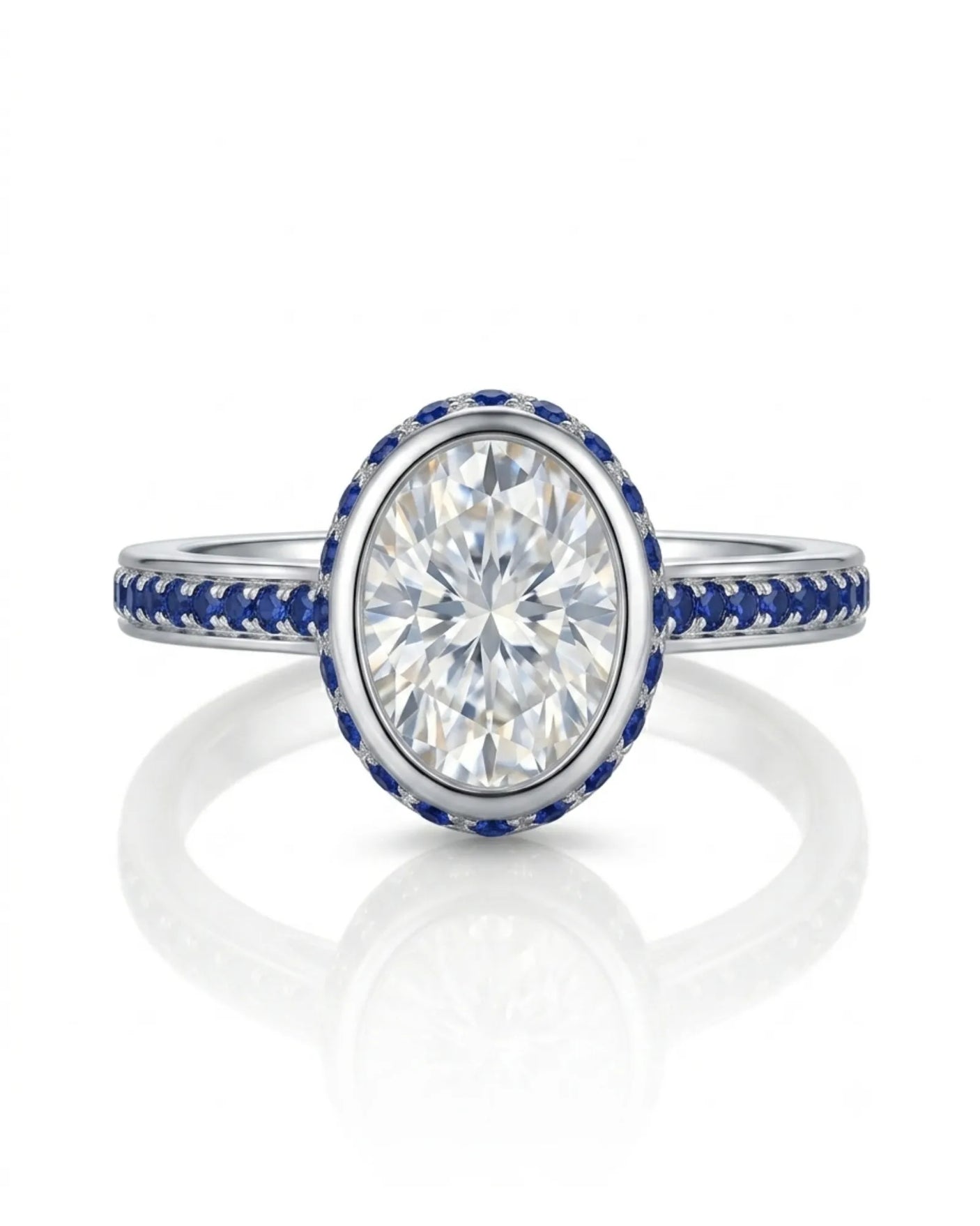 Oval natural diamond ring framed by round blue sapphires in polished 18K white gold | SARATTI