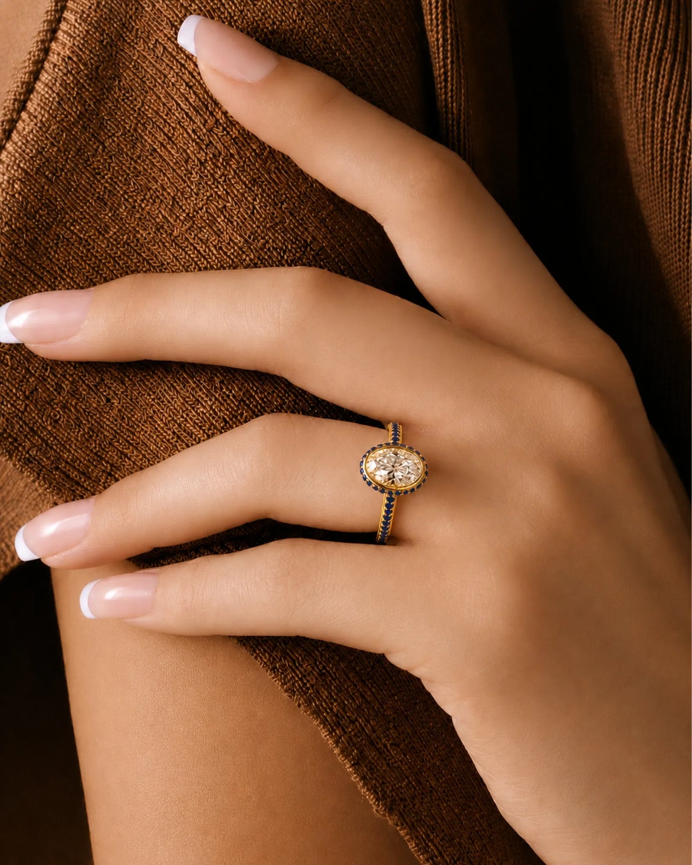 Oval natural diamond ring surrounded by round blue sapphires in polished 18K yellow gold | SARATTI