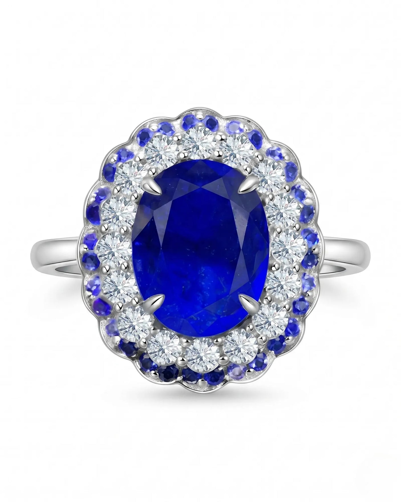 Oval natural sapphire ring framed by round diamonds and blue sapphires in 18K white gold | SARATTI