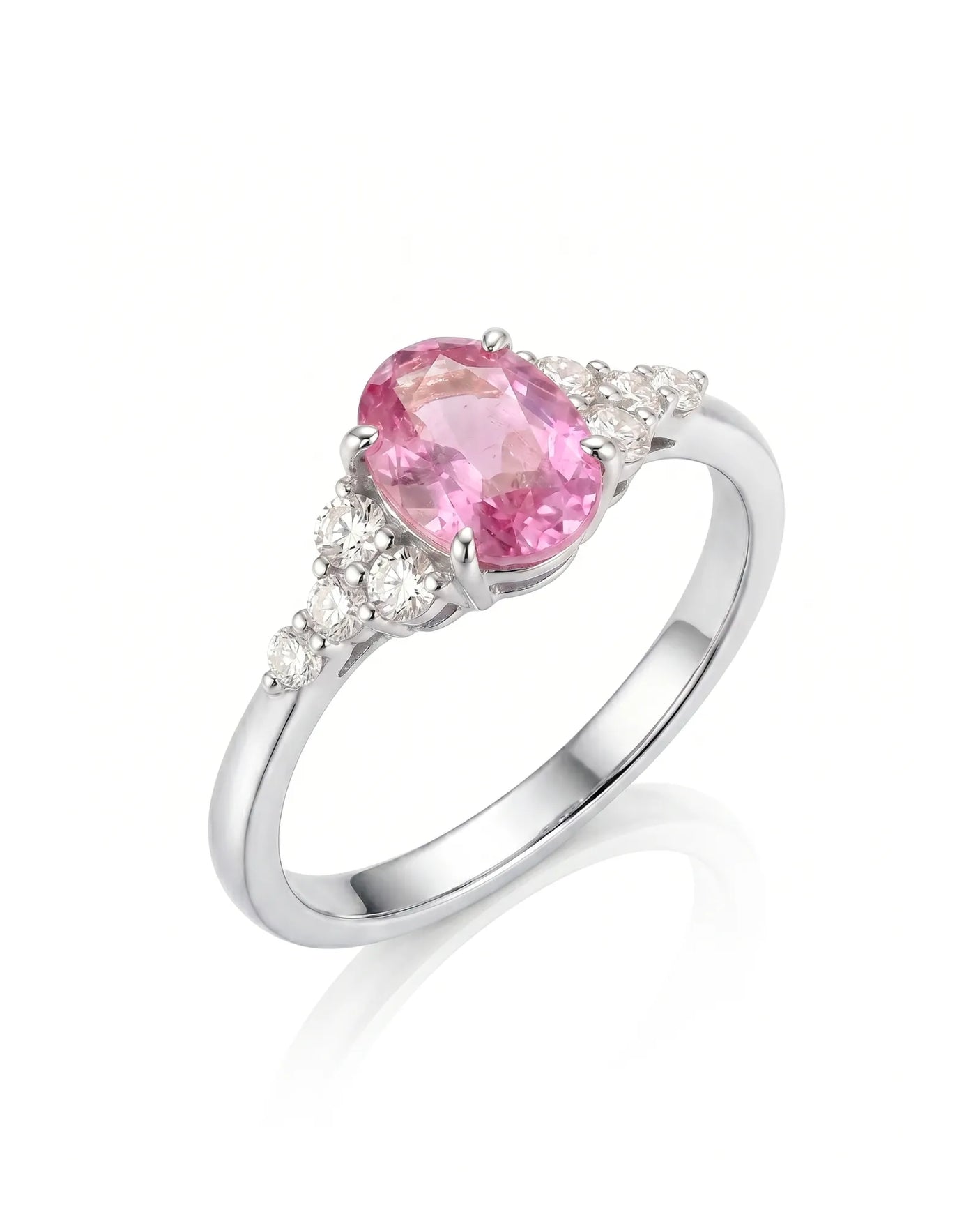 Oval pink sapphire ring with round diamond side stones in 18K white gold | SARATTI