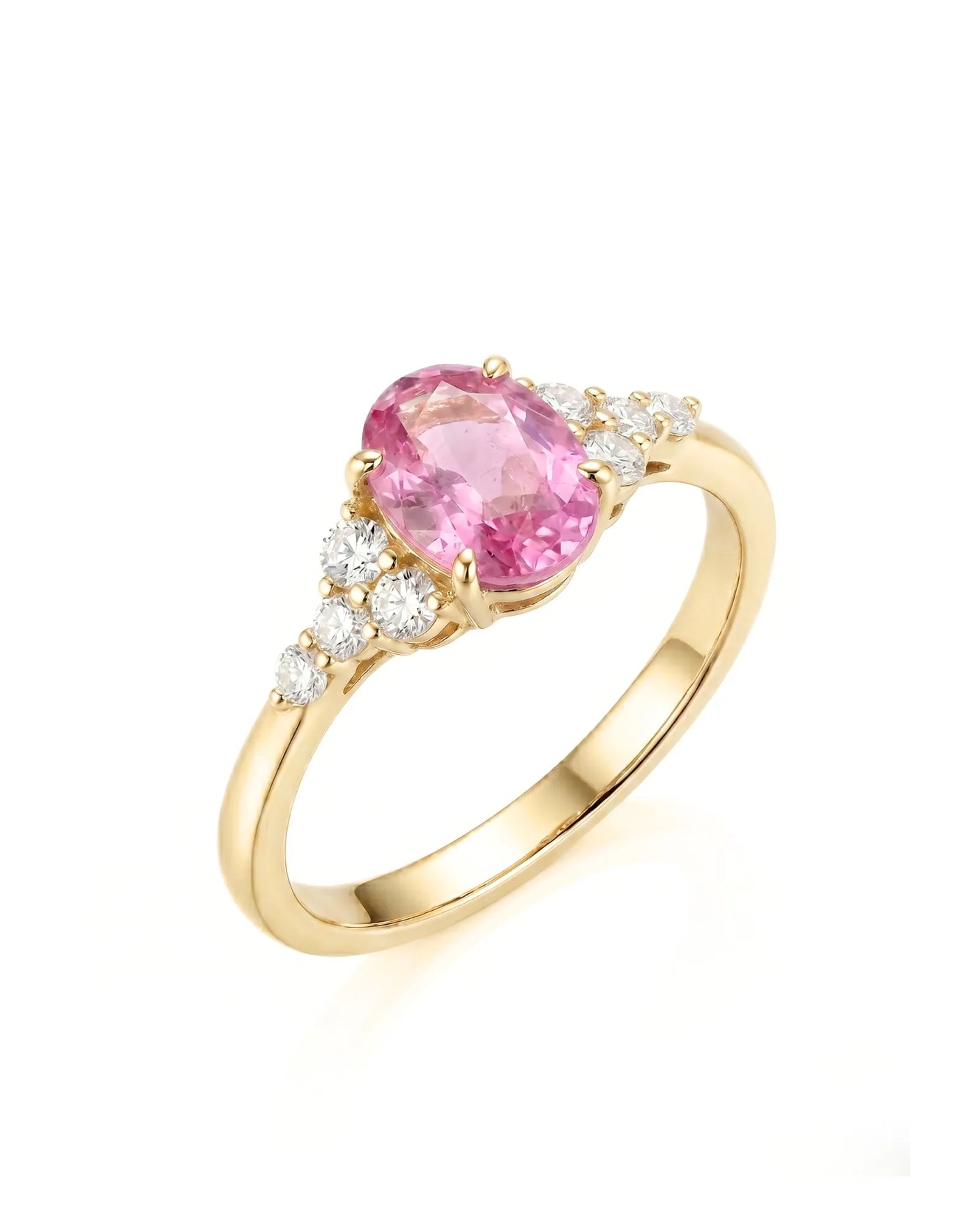 Oval pink sapphire ring with round diamond side stones in 18K yellow gold | SARATTI
