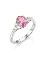 Oval pink sapphire ring with round diamond side stones in polished platinum | SARATTI
