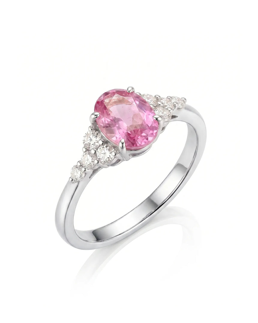 Oval pink sapphire ring with round diamond side stones in polished platinum | SARATTI