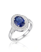 Oval royal blue sapphire ring with baguette diamond sunburst halo in polished platinum | SARATTI