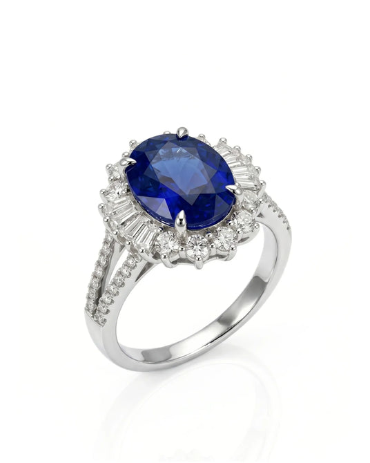 Oval royal blue sapphire ring with diamond halo and split shank in 18K white gold | SARATTI
