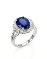 Oval royal blue sapphire ring with diamond halo and split shank in platinum | SARATTI
