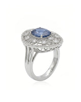 Oval royal blue sapphire ring with filigree diamond halo in platinum | SARATTI