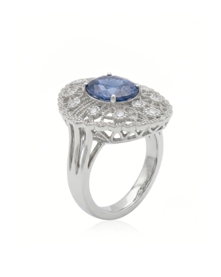 Oval royal blue sapphire ring with filigree diamond halo in platinum | SARATTI