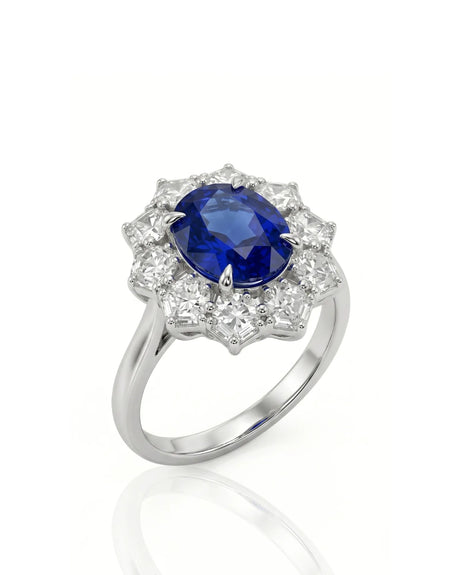 Oval royal blue sapphire ring with floral diamond halo in 18K white gold | SARATTI