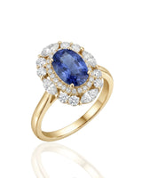 Oval royal blue sapphire ring with round diamond halo in 18K yellow gold | SARATTI