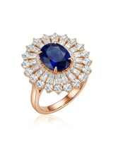 Oval royal blue sapphire ring with sunburst diamond halo in 18K rose gold | SARATTI