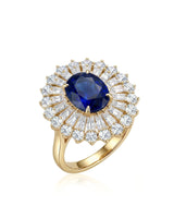 Oval royal blue sapphire ring with sunburst diamond halo in 18K yellow gold | SARATTI