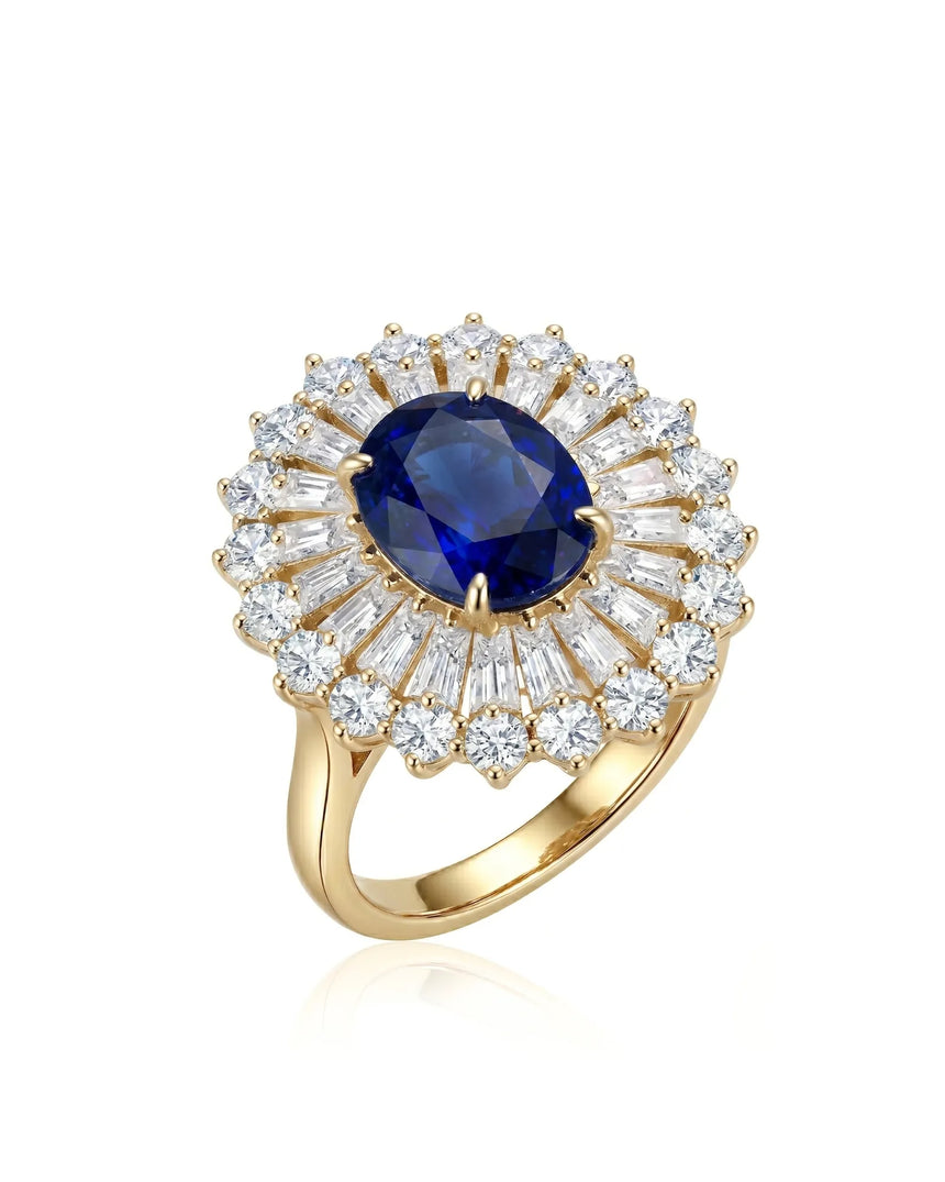 Oval royal blue sapphire ring with sunburst diamond halo in 18K yellow gold | SARATTI