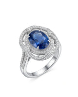 Oval royal blue sapphire ring with triple diamond halo in 18K white gold | SARATTI