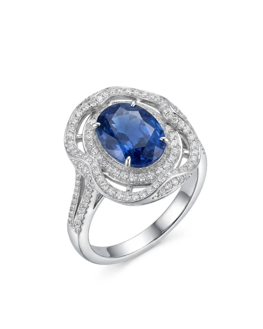 Oval royal blue sapphire ring with triple diamond halo in 18K white gold | SARATTI