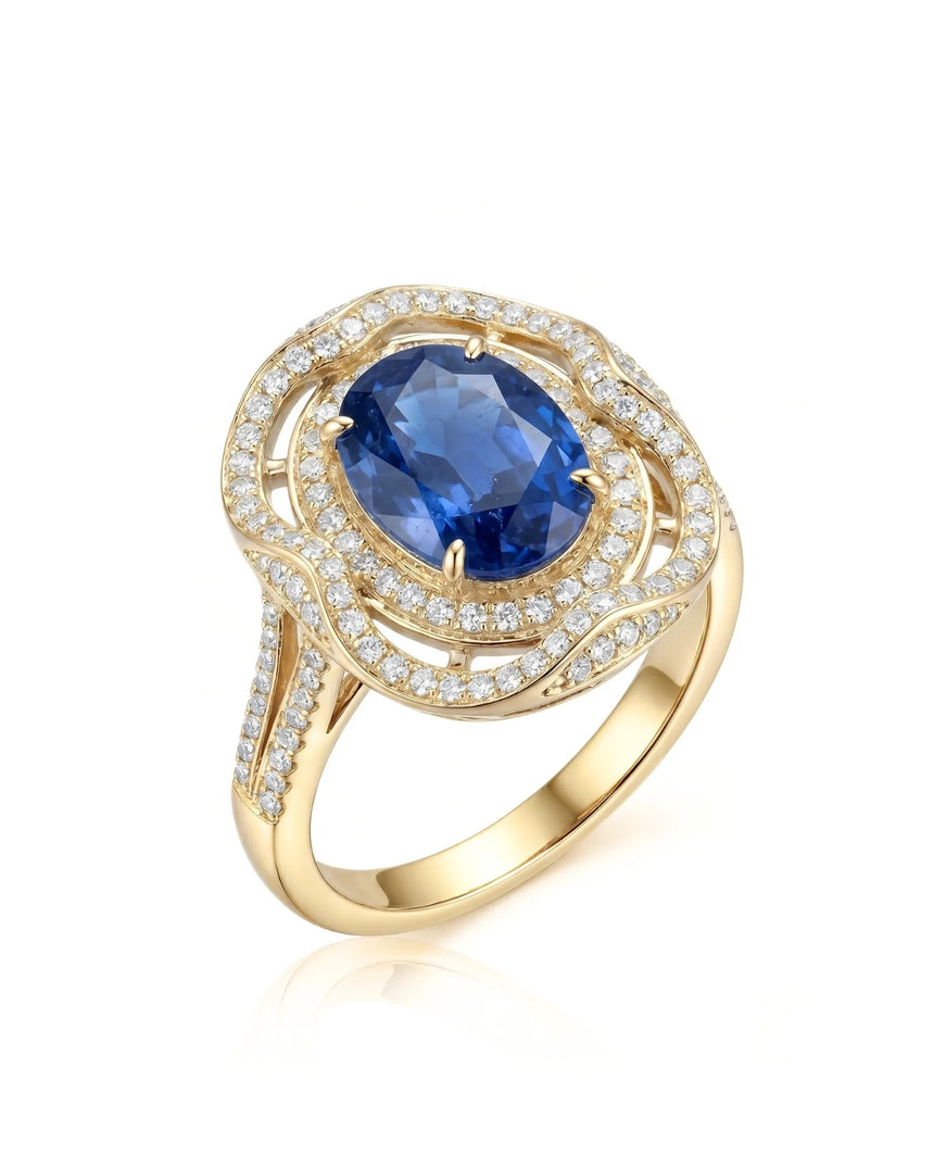 Oval royal blue sapphire ring with triple diamond halo in 18K yellow gold | SARATTI