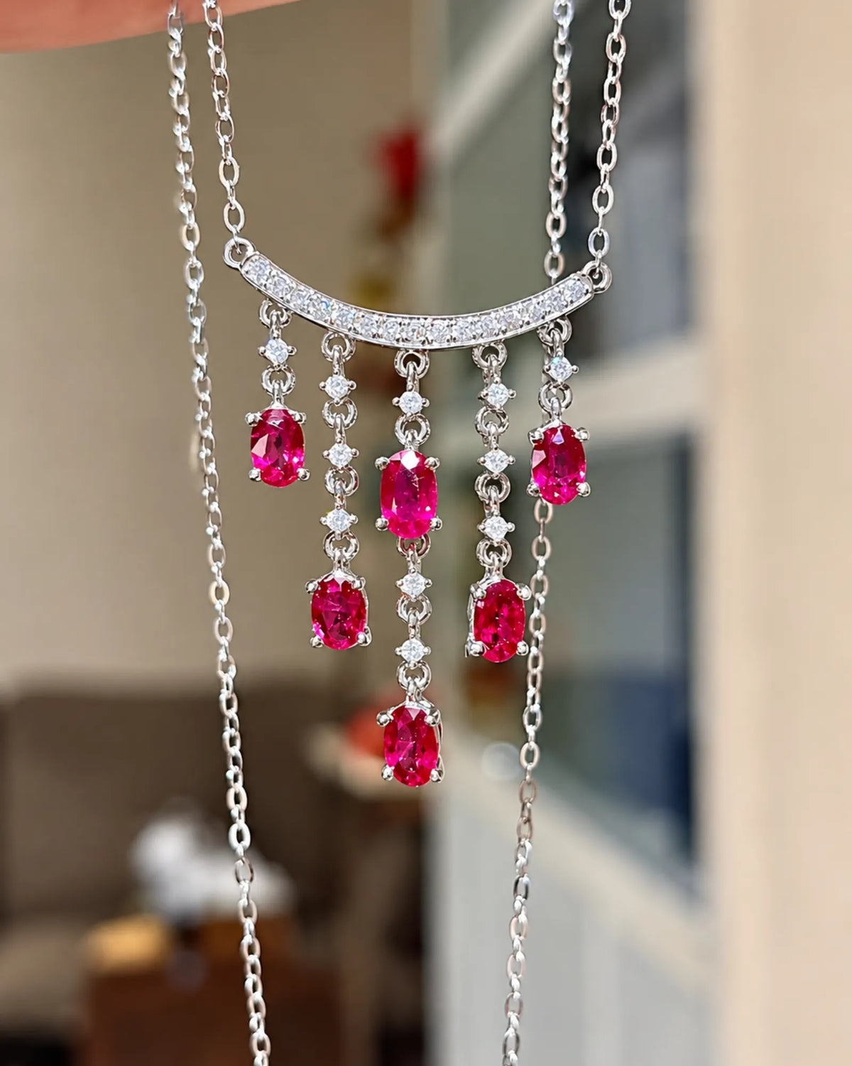 Oval ruby necklace featuring 2.01 ct of vivid red gemstones with delicate diamond accents in platinum | SARATTI