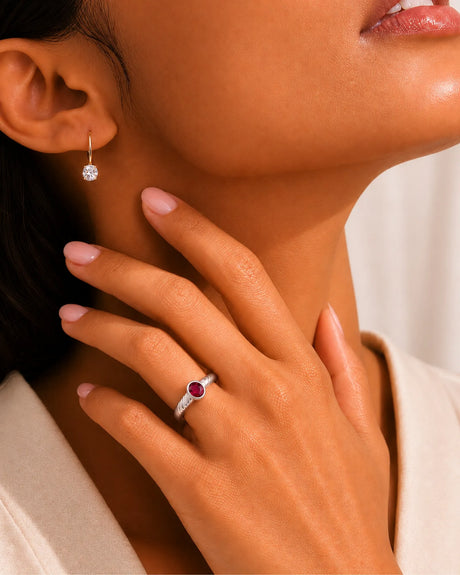 Oval ruby ring in 18K white gold with triple wave motif and smooth bezel setting | SARATTI
