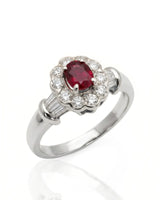 Oval ruby ring with diamond halo and baguette accents in polished platinum | SARATTI