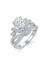 Pear-shaped moissanite engagement ring with tiara-inspired crown, round accents, and 18K white gold setting | SARATTI