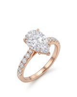 Pear cut moissanite engagement ring with scallop-set round side stones in 18K rose gold | SARATTI