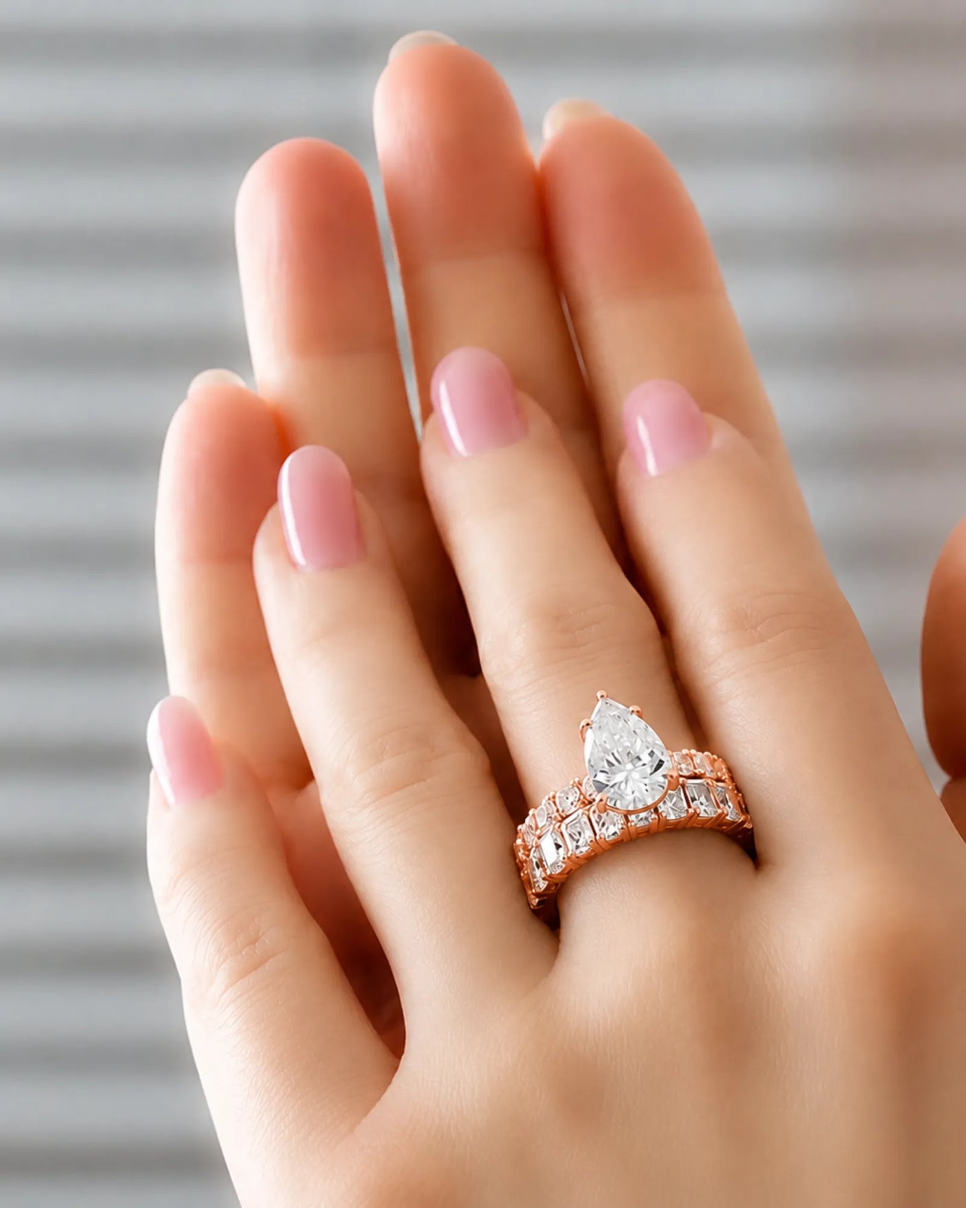 Pear cut moissanite ring in rose gold with brilliant shoulder accents and elegant profile | SARATTI